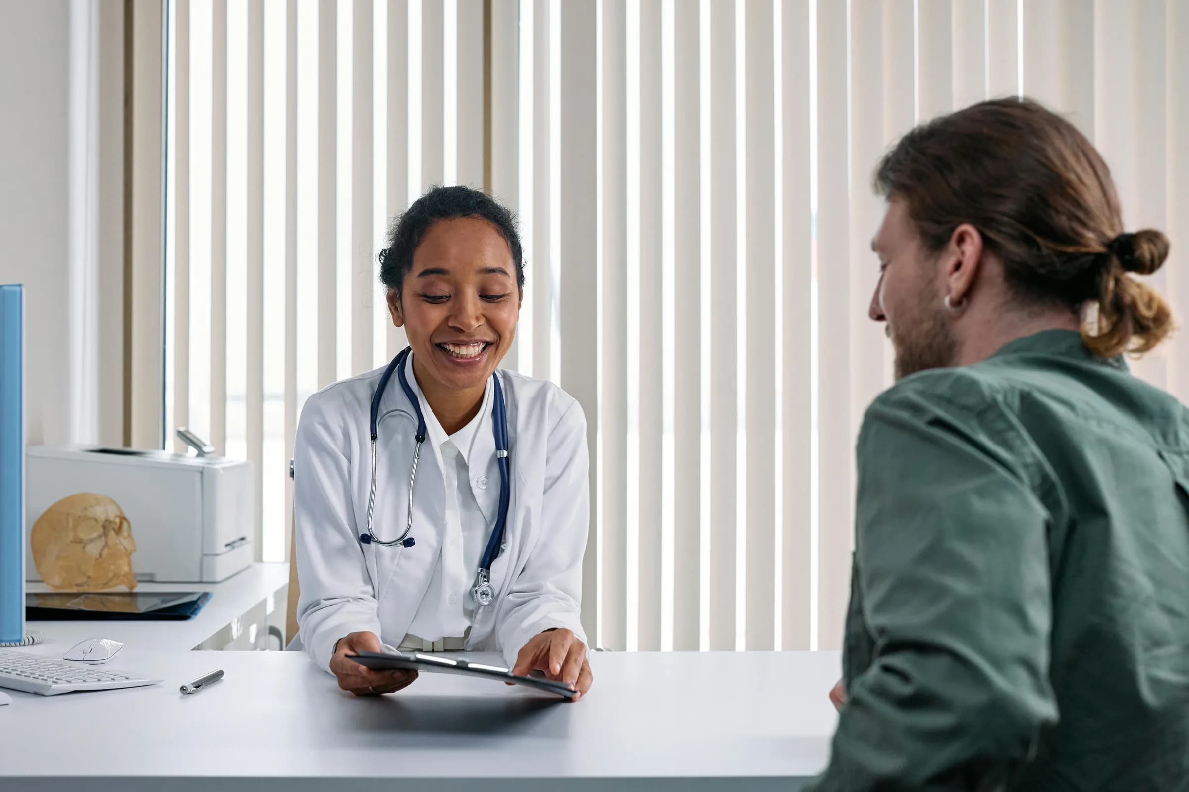 Persona en consulta médica, tono cálido y esperanzador